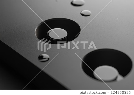 Abstract black surface with cylinders and water droplets creating modern design 124350535