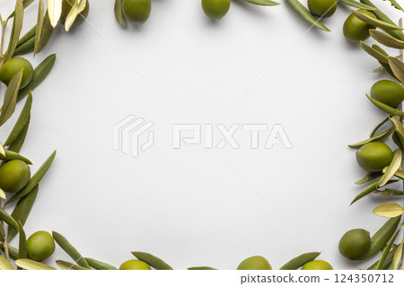 Minimalistic frame made of fresh green olives and branches on a white background 124350712