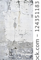 The aged plaster wall showcases cracks, peeling paint, and a worn texture, making it a great fit for urban decay themes. It exudes history and resilience, perfect for vintage decor 124351183