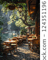 Tranquil riverside caf with cozy outdoor seating, surrounded by lush greenery and a stunning mountain backdrop, perfect for a peaceful day out 124351196