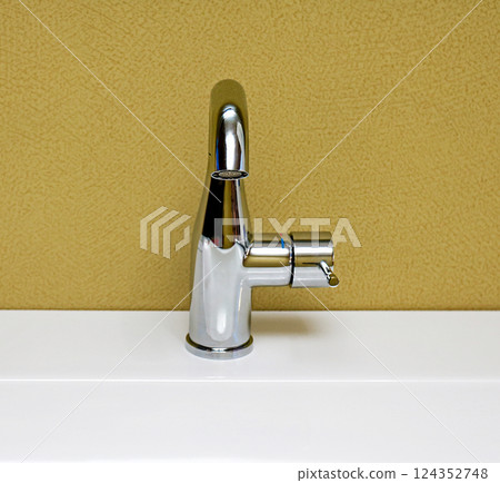 Small faucet on bathroom sink Small faucet on bathroom sink 124352748