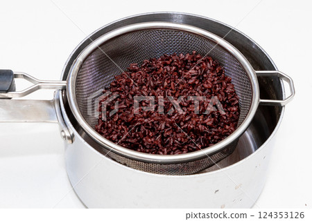Cooked brown rice in strainer Cooked brown rice in strainer 124353126