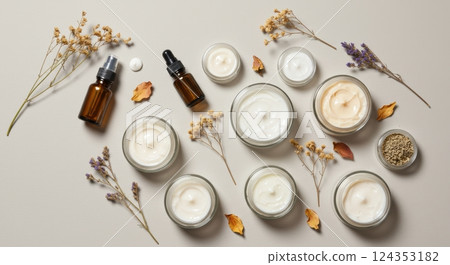 Natural skincare products with dried flowers and essential oils on neutral background 124353182
