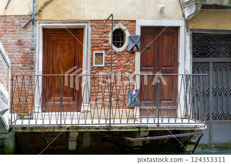 Entrance doors in Venice canal Entrance doors in Venice canal 124353311