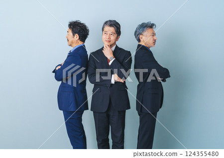 A middle-aged male business person struggling between two people 124355480