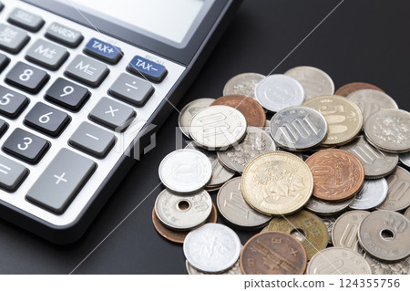 Coins and calculator on a black background 124355756