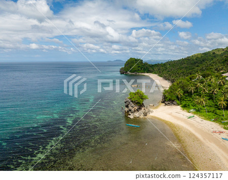 Boat floating over clear sea water. Beach with white sand in Santa Fe, Tablas, Romblon. Philippines. 124357117