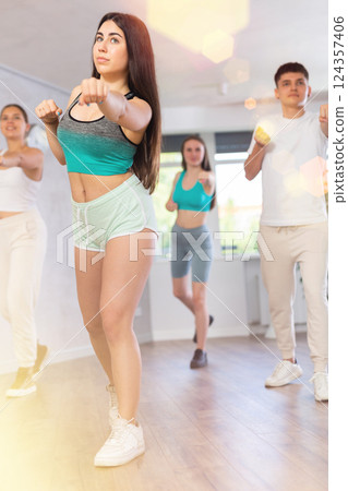 Boys and girls performing contemporary dance in studio Boys and girls performing contemporary dance in studio 124357406