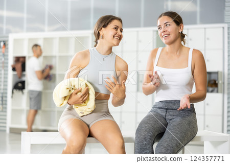 Female climbers sharing stories in climbing gym locker room 124357771