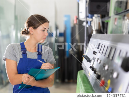 Portrait of foreman girl with folder of documents in glass workshop 124357781