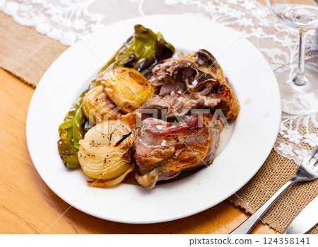Fried lamb served with potatoes and peppers 124358141