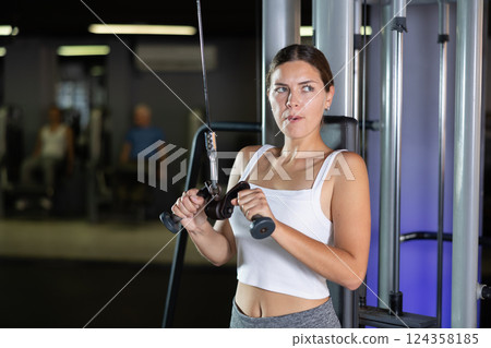 Young woman training with straps in gym Young woman training with straps in gym 124358185