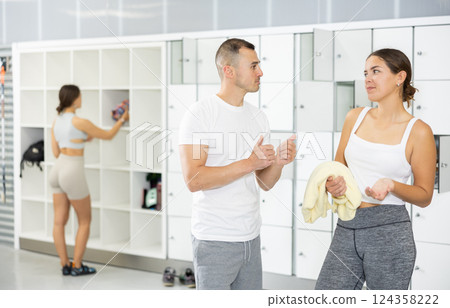 Young man and woman talking in locker room Young man and woman talking in locker room 124358222