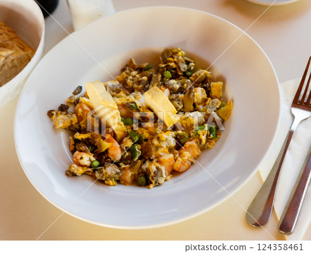 Scramble with mushrooms and shrimp served on platter 124358461