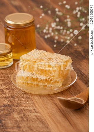 Comb honey on wood grain 124360075
