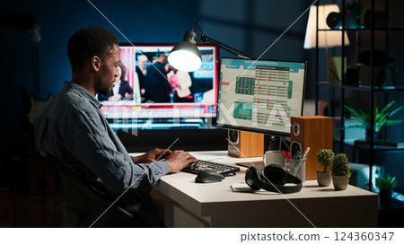 Operating from home setup, male freelancer evaluating monetary data and searching international capital funds sources to help expand the business. Fiscal analyst validates budget balance. Camera A. Operating from home setup, male freelancer evaluating monetary data and searching international capital funds sources to help expand the business. Fiscal analyst validates budget balance. Camera A. 124360347