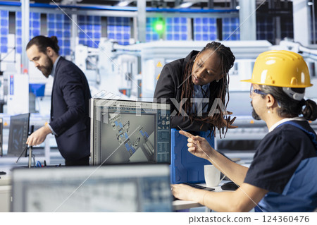 Photovoltaics facility team leader supervising work done by technician to improve production output. Solar panels plant engineer showing african american manager identified system errors 124360476
