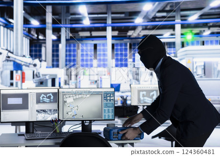 Masked man sneaking into solar panel plant at night to steal equipment, planning to sell it on black market. Thief in photovoltaics factory running with inventory gear, grabbing tool box 124360481