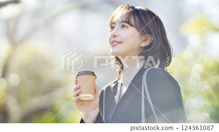 Young business woman walking in a suit Young business woman walking in a suit 124361087