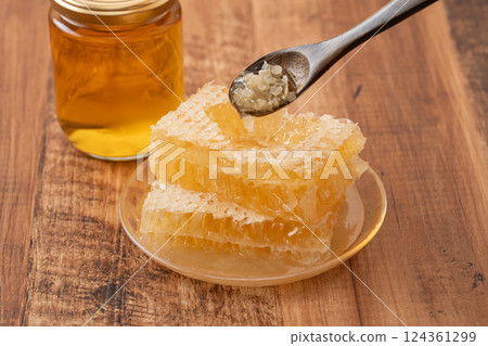 Thick com honey on a wooden background Thick com honey on a wooden background 124361299