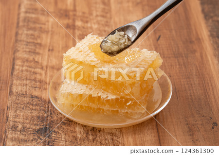 Thick com honey on a wooden background Thick com honey on a wooden background 124361300