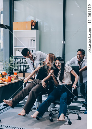 Asian office colleagues and friends enjoy a daytime BBQ with pizza and beer, celebrating Halloween and cheering for their favorite soccer team, creating a lively atmosphere filled with joy. Asian office colleagues and friends enjoy a daytime BBQ with pizza and beer, celebrating Halloween and cheering for their favorite soccer team, creating a lively atmosphere filled with joy. 124361519