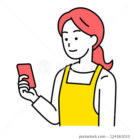 A woman in an apron looking at a smartphone screen A woman in an apron looking at a smartphone screen 124362033