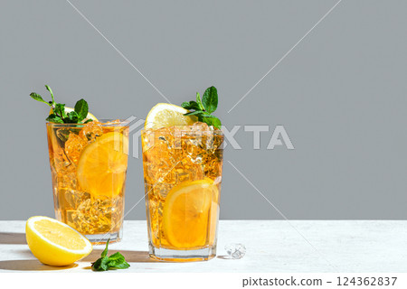 Glasses of iced tea with lemon slices, mint and ice 124362837