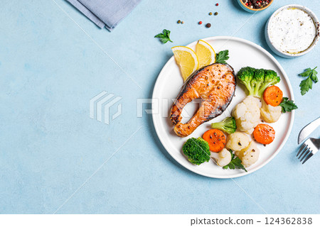Roasted salmon fish steak with steamed vegetables Roasted salmon fish steak with steamed vegetables 124362838