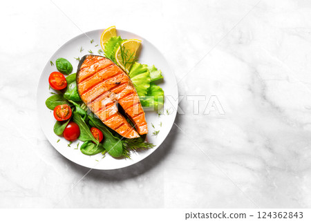 Grilled Salmon fish steak with green vegetable salad 124362843