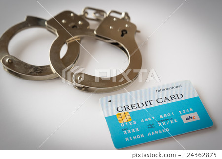 Handcuffs and credit cards, card crimes, special fraud, criminal images, financial crimes, illegal acts, unauthorized use Handcuffs and credit cards, card crimes, special fraud, criminal images, financial crimes, illegal acts, unauthorized use 124362875