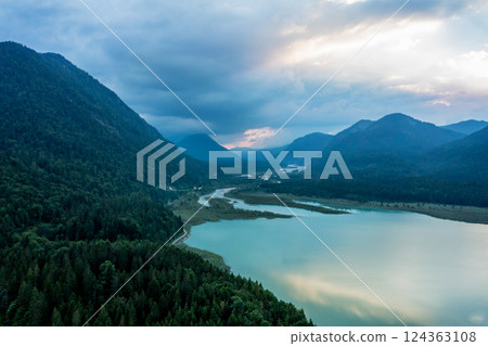 Drone shot at sunset in Isar Valley in Bavarian Alps, with the lake Sylvenstein surrounded by mountains 124363108
