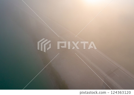 Drone image at sunrise with Sylvenstein Bridge covered in fog Drone image at sunrise with Sylvenstein Bridge covered in fog 124363120