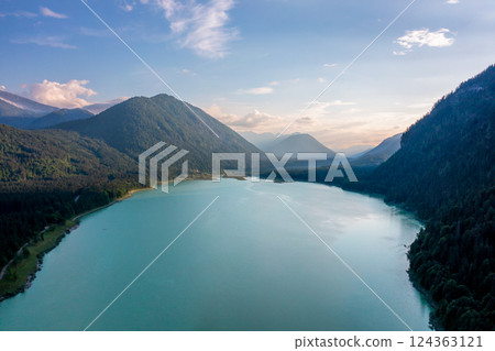 Drone image at sunset with Lake Sylvenstein surrounded by mountains in the Upper Bavaria region, Germany Drone image at sunset with Lake Sylvenstein surrounded by mountains in the Upper Bavaria region, Germany 124363121