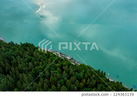 Drone aerial view with Sylvenstein lakeshore and pine forest, in Bavaria, Germany 124363139