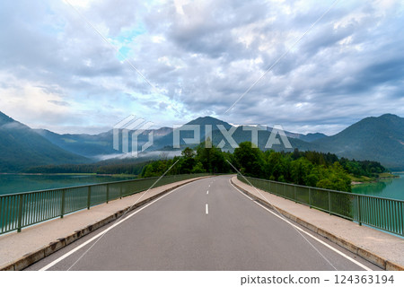 Sylvenstein Lake Bridge and the Bavarian Alps at the horizon, on a sunny day in summer Sylvenstein Lake Bridge and the Bavarian Alps at the horizon, on a sunny day in summer 124363194