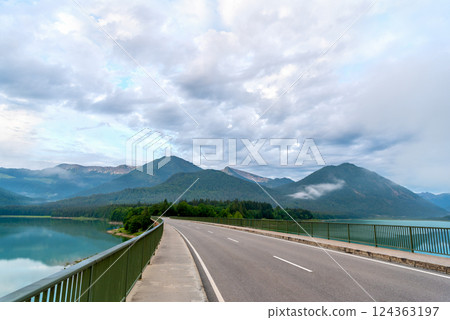 Winding bridge over Lake Sylvenstein in an alpine scenery, in Karwendel Mountains Winding bridge over Lake Sylvenstein in an alpine scenery, in Karwendel Mountains 124363197