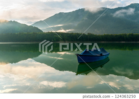 Boat on Lake Sylvenstein and the mountain reflection in the water 124363250