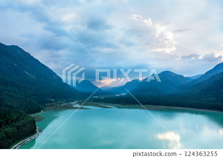 Drone aerial view at sunset with Lake Sylvenstein surrounded by Bavarian Alps, in Germany Drone aerial view at sunset with Lake Sylvenstein surrounded by Bavarian Alps, in Germany 124363255