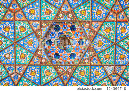 beautiful carved wooden painted ceiling in palace in Museum of Art of Uzbekistan with traditional Uzbek ornaments and colorful oriental patterns in Tashkent 124364748