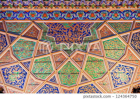 painted carved wooden background with traditional Uzbek ornaments and colorful oriental patterns in Uzbekistan 124364750