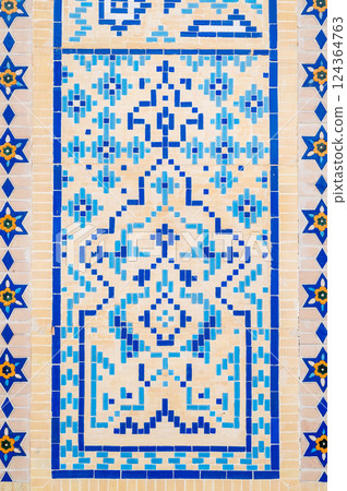 ancient old wall of a Muslim mosque decorated with ceramic tiles with a traditional oriental Uzbek Islamic pattern in Uzbekistan ancient old wall of a Muslim mosque decorated with ceramic tiles with a traditional oriental Uzbek Islamic pattern in Uzbekistan 124364763
