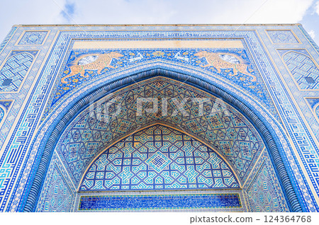 arch of Muslim mosque decorated with ceramic tiles with a traditional Uzbek oriental pattern in Uzbekistan 124364768