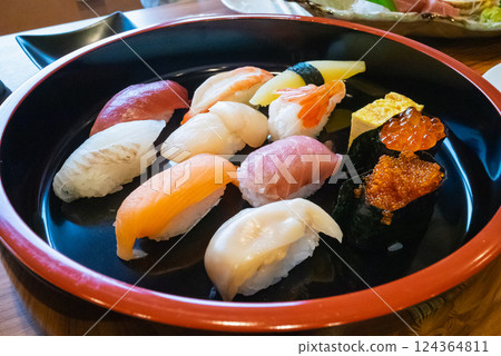 Assorted nigiri sushi including tuna, salmon, shrimp, scallops, etc. Assorted nigiri sushi including tuna, salmon, shrimp, scallops, etc. 124364811