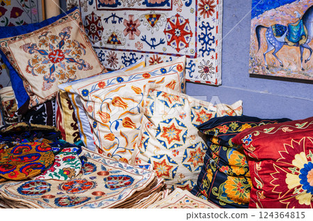 traditional Uzbek handmade pillows and vintage carpet in the interior of house in Uzbekistan. Culture of Central Asia traditional Uzbek handmade pillows and vintage carpet in the interior of house in Uzbekistan. Culture of Central Asia 124364815