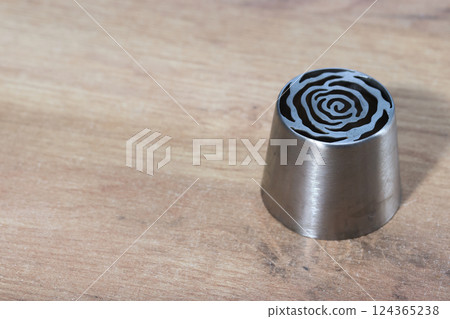 Tip for making marshmallow tulips. Pastry tip made of metal. Close-up view. 124365238