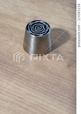 Tip for making marshmallow tulips. Pastry tip made of metal. Close-up view. Tip for making marshmallow tulips. Pastry tip made of metal. Close-up view. 124365239