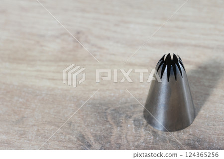 Conical tip for making marshmallows. Made from stainless steel. Close-up. Conical tip for making marshmallows. Made from stainless steel. Close-up. 124365256