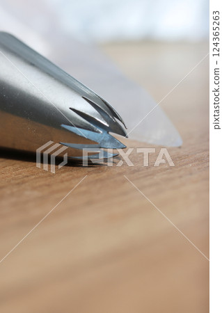 Pastry tip made from stainless steel. For making marshmallows. Plastic pastry bag included. Close-up. 124365263