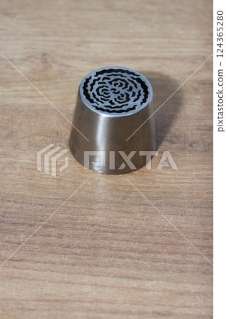 Tip for making marshmallow tulips. Pastry tip made of metal. Close-up Tip for making marshmallow tulips. Pastry tip made of metal. Close-up 124365280